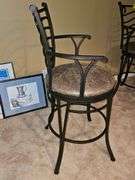 Metal bar stool with padded seat.