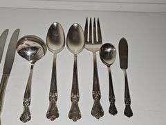 Old company plate flatware possibly Signature Rose pattern. Four dinner forks, four salad forks, five soup spoons, four iced teaspoons, four dinner knives, two serving spoons, one ladle, one cold meat fork, one sugar spoon, and one butter knife. No monogram.  Circa 1940s