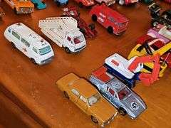 Grouping of diecast tractor-trailer toys and others from various makers.