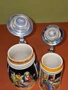 2 steins. One is 7.25 in from West Germany,  8.25 in is from Germany