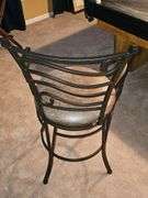 Metal bar stool with padded seat.
