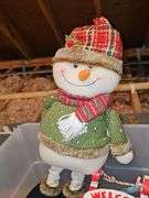 Tub of Christmas decor and doormat.