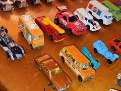 Grouping of diecast tractor-trailer toys and others from various makers.