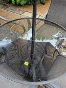 Glass top table, four swivel chairs, and umbrella.
