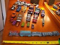 Diecast vehicles. All have been played with. The train in the front is Midge Toy, most of the rest are Tootsie Toy.