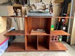Multi-tiered bookshelf and contents sitting on shelf…..60-1/4 x 16 x 34-1/2…..does have scratching…..BACKGROUND CONTENTS NOT INCLUDED