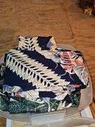 Small container of Hawaiian leis and shirts.