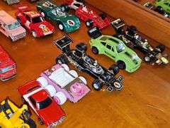 Grouping of diecast tractor-trailer toys and others from various makers.