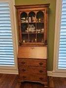 Wood secretary with two doors and 3 drawers. Keys work locks properly. 26.5 x 15.5x 71.5 in tall. Content's not included.