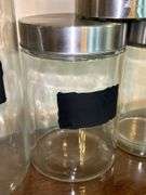 Set of (3) glass and stainless storage jars and (1) all stainless…..heights range from 9” down to 5”