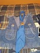 Little cowpoke leather chaps and vest in blue, natural leather color chaps, and pants with fringe and Teepee look on front, cowboy hat and drum.