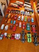 Grouping of diecast tractor-trailer toys and others from various makers.