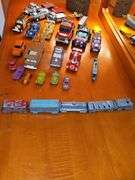 Diecast vehicles. All have been played with. The train in the front is Midge Toy, most of the rest are Tootsie Toy.