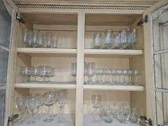 Cabinet of stemware. Matching set of 11 iced beverages, 11 wine glasses, 12 coupe champagne glasses. Matching set of 8 "H" monogrammed glasses, four shrimp cocktail stems with liners and more. See all photos.