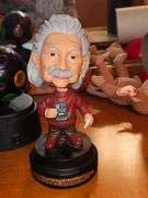 Magnetic dart board (missing 1 red dart), bobblehead Einstein needs battery, and mini Disco light works.