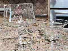 Cabinet of stemware. Matching set of 11 iced beverages, 11 wine glasses, 12 coupe champagne glasses. Matching set of 8 "H" monogrammed glasses, four shrimp cocktail stems with liners and more. See all photos.