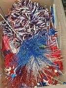 Two tubs. One containing artificial flowers, one containing 4th of July decorative items.