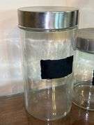 Set of (3) glass and stainless storage jars and (1) all stainless…..heights range from 9” down to 5”