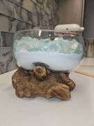 Beautiful molten glass bowl filled with sand and aqua blue crushed rock sitting on teak driftwood...