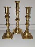 Three brass candlesticks and two Lenox tea lights