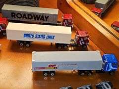 Grouping of diecast tractor-trailer toys and others from various makers.
