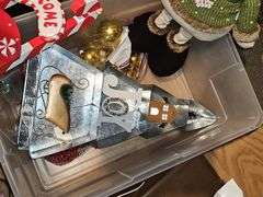 Tub of Christmas decor and doormat.