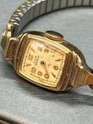 2 vintage ladies watches with stretchy bands…..top is by Timex and lower is 10K gold filled by Elgin and needs hands repaired