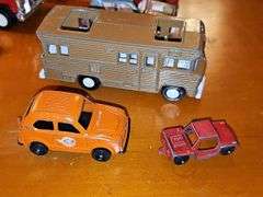 Diecast vehicles. All have been played with. The train in the front is Midge Toy, most of the rest are Tootsie Toy.