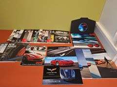 Grouping of Corvette dealership brochures, America sports car magazines, and new roads magazines.