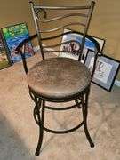 Metal bar stool with padded seat.