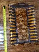 Miscellaneous grouping. Mikasa cake knife, Kirby farmhouse by the cat's meow, double, wicker breadbasket, and handled basket and placemats. See all photos for more details