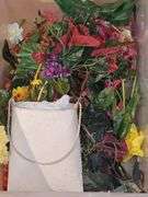 Two tubs. One containing artificial flowers, one containing 4th of July decorative items.