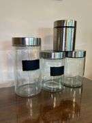 Set of (3) glass and stainless storage jars and (1) all stainless…..heights range from 9” down to 5”