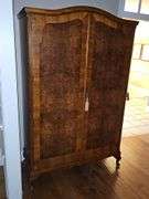 Fabulous antique armoire With burl wood inlay, repurposed as a cabinet. 48 x21.5x 78 in tall.