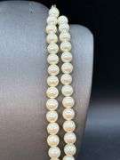 Nice looking double strand of pearl-like beads with adjustable fastener