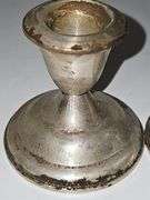 Pair of sterling weighted candlesticks. 2.75 in tall.