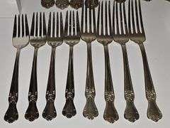 Old company plate flatware possibly Signature Rose pattern. Four dinner forks, four salad forks, five soup spoons, four iced teaspoons, four dinner knives, two serving spoons, one ladle, one cold meat fork, one sugar spoon, and one butter knife. No monogram.  Circa 1940s