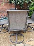 Glass top table, four swivel chairs, and umbrella.