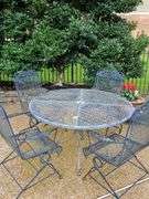 Iron patio table and four spring rocking chairs.