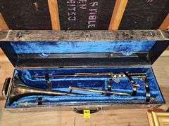 King brand trombone with regular slide and keyed slide. Keys need oil. Mouth mouthpiece included along with music stand.