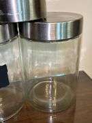 Set of (3) glass and stainless storage jars and (1) all stainless…..heights range from 9” down to 5”