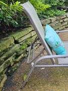 Adjustable patio lounge chair with cushion.