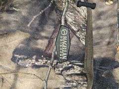 Two camo duffel bags. The smaller one has winter gloves in it.