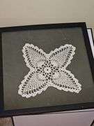 Framed hand crocheted doily. 13 x 13 in