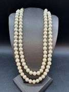 Nice looking double strand of pearl-like beads with adjustable fastener
