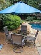 Glass top table, four swivel chairs, and umbrella.