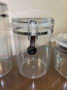 Set of (4) OGGI acrylic canisters…..only 1 has spoon….heights range from 4” to 9” tall…..another was found after initial listing