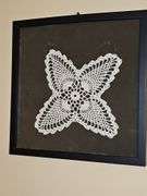Framed hand crocheted doily. 13 x 13 in