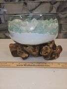 Beautiful molten glass bowl filled with sand and aqua blue crushed rock sitting on teak driftwood...