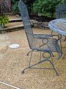Iron patio table and four spring rocking chairs.